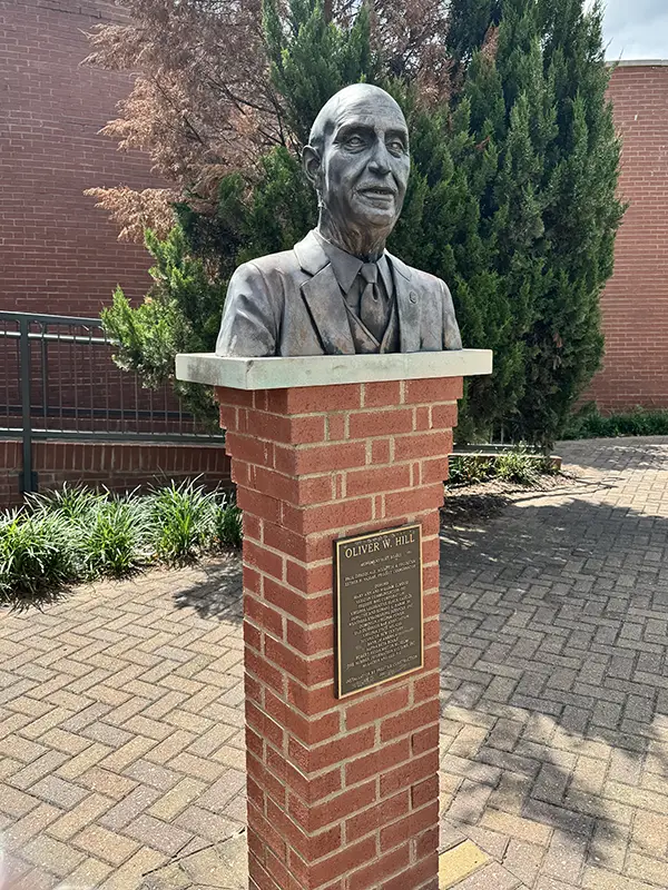 Statue bust of Oliver Hill on a brick column